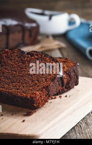 Slices of chocolate cake on wooden cutting board, rustic style Stock Photo