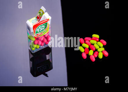 Tic tacs isolated on dark background. Tic tacs are manufactured by Italian confectioner Ferrero and were first produced in 1968. Stock Photo