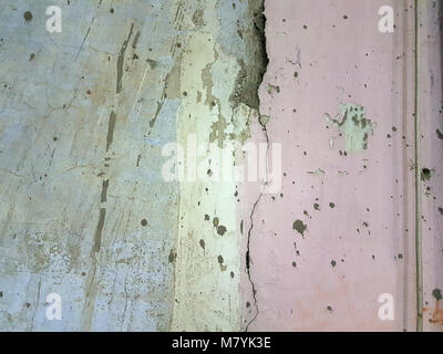 Abstract grunge background old wall with cracks and crumbling stucco stripes blue, yellow and pink color. Stock Photo