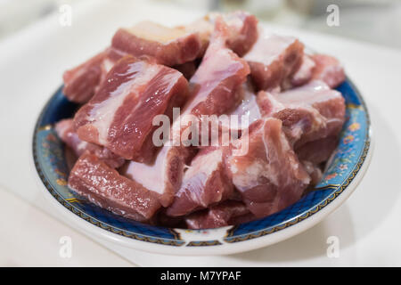 Raw pork spare ribs in ceramic bowl Stock Photo