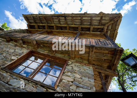 Window cloud reflections old stone and wood house Stock Photo