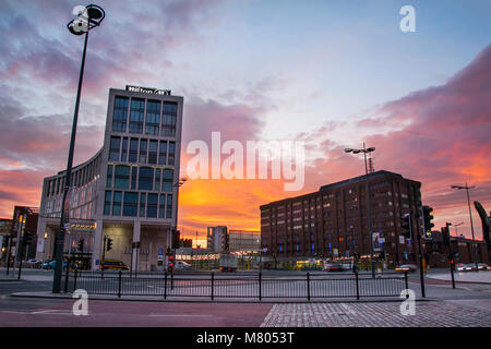 Albert Dock; Liverpool; Merseyside. 14th March 2018. UK Weather; Colourful sunrise over the city waterfront. Early morning sun glinting on the windows with reflections on the city's landmarks.. Credit: MediaWorldImages/AlamyLiveNews. Stock Photo