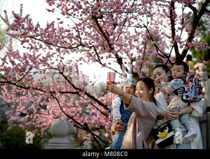 Xi'an, China's Shaanxi Province. 14th Mar, 2018. Visitors take selfie at the Xingqing park in Xi'an, northwest China's Shaanxi Province, March 14, 2018. Credit: Liu Xiao/Xinhua/Alamy Live News Stock Photo