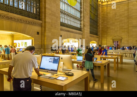 People browsing and using  Apple products at The Apple Store located inside  Grand Central Terminal , New York City , New York ,USA Stock Photo