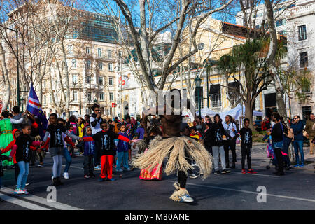 African dancer in costume at a procession on the Av. da Liberdade in Lisbon. Stock Photo