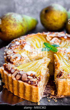 Delicious  cake with half poached pears and almond flakes Stock Photo