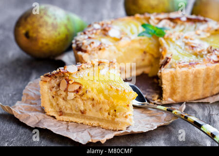 Delicious  cake with half poached pears and almond flakes Stock Photo
