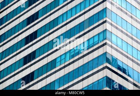 Angle view of glass and steel exterior of a modern office building with strong diagonal lines and perspective as abstract background Stock Photo