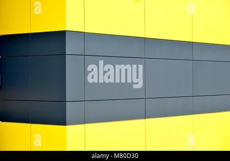 Perspective abstract background of yellow and gray aluminium cladding on the exterior of a modern warehouse Stock Photo