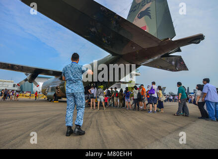 Singapore - Feb 10, 2018. People coming to the Lockheed C-130 Hercules aircraft of Singapore Air Force (RSAF) in Changi, Singapore. Stock Photo