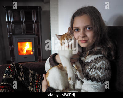 indoor shot young girl with cat Stock Photo