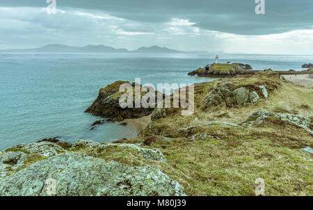 UK, Anglesey, Newborough, 11th March 2018. A view from Llanddwyn Island with Twr Bach lighthouse and the Llyn Peninsula in the  background.