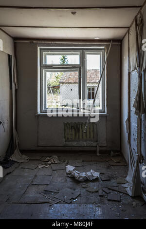 Ruined room and window in the abandoned soviet building Stock Photo