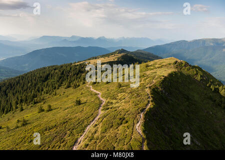 Aerial image at sunset over amazing mountain landscapes with walking tracks at Parc national de la Vanoise in the French Alps Stock Photo