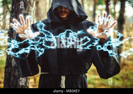 the black monk pointing his finger in the woods Stock Photo