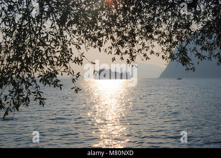 Little island in the middle of a sunset reflexing on Iseo Lake - Montisola - Italy Stock Photo