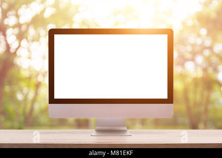 Modern desktop computer on wooden table and abstract light blur and bokeh background. Saved with clipping path. Work on nature and everywhere Concept Stock Photo
