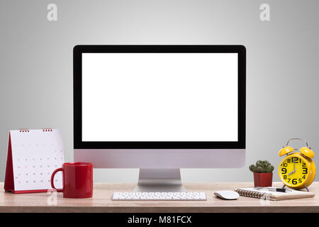 Modern desktop computer, Coffee cup, alarm clock, notebook and calendar on wooden table. Studio shot isolated on white background. Saved with clipping Stock Photo