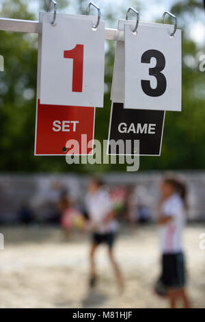 Scoreboard against the people playing beach tennis Stock Photo
