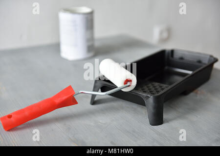 Paint roller and painting tray on a table Stock Photo