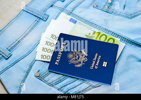 Red russian Passport with money bills on jeans. The concept of travel. Stock Photo
