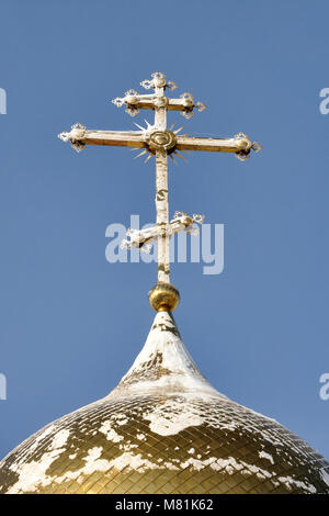 Gilded Russian Orthodox Cross on the Church Cupola in the Snow Stock Photo
