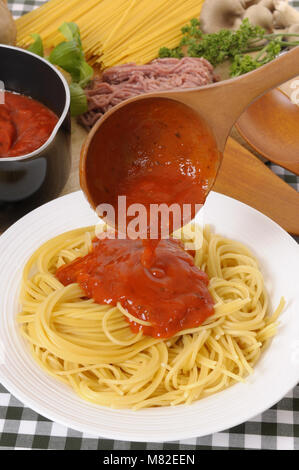 Bowl of spaghetti bolognese with ingredients in the background. Stock Photo