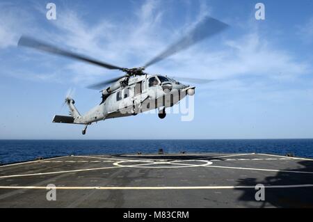 180312-N-QR145-155 MEDITERRANEAN SEA (March 12, 2018)  An MH-60S Sea Hawk helicopter, assigned to the 'Ghost Riders' of Helicopter Sea Combat Squadron (HSC) 28, takes off from the Blue Ridge-class command and control ship USS Mount Whitney (LCC 20) March 12, 2018. Mount Whitney, forward-deployed to Gaeta, Italy, operates with a combined crew of U.S. Navy Sailors and Military Sealift Command civil service mariners. (U.S. Navy photo by Mass Communication Specialist 3rd Class Krystina Coffey/ Released) Stock Photo