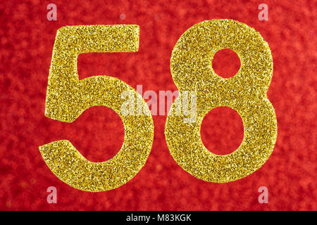 Number fifty-eight gold color over a red background. Anniversary. Horizontal Stock Photo