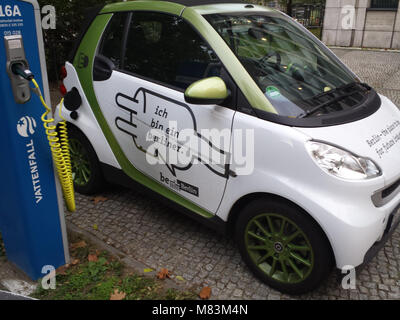 Electric car connected to charging station, Berlin, Germany Stock Photo
