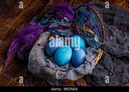 Unusually painted in dark blue and blue colors Easter eggs. Easter still life. Stock Photo