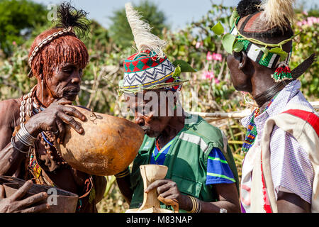 Honoured Guests At A Bull Jumping Ceremony Are Offered A Locally Brewed Beer To Drink, Dimeka, Omo Valley, Ethiopia Stock Photo