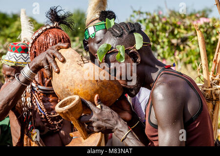 Honoured Guests At A Bull Jumping Ceremony Are Offered A Locally Brewed Beer To Drink, Dimeka, Omo Valley, Ethiopia Stock Photo