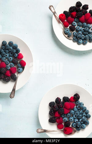 Fruit salad with Various fresh summer berries in white plate . Top view Stock Photo