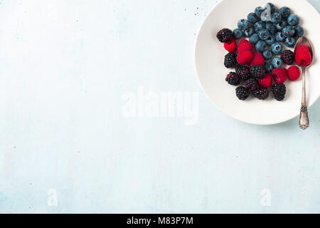 Fruit salad with Various fresh summer berries in white plate . Top view Stock Photo