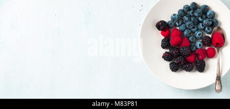 Fruit salad with Various fresh summer berries in white plate . Top view Stock Photo