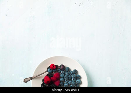 Fruit salad with Various fresh summer berries in white plate . Top view Stock Photo