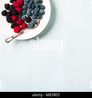 Fruit salad with Various fresh summer berries in white plate . Top view Stock Photo