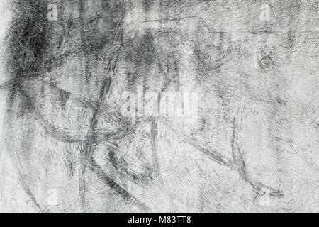 closeup of a rustic off-white plastered wall with some black stains to be used as a background Stock Photo