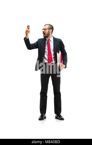 Angry businessman talking on the phone isolated over white background in studio shooting Stock Photo