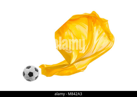 Soccer ball and Smooth elegant transparent yellow cloth isolated or separated on white studio background. Stock Photo