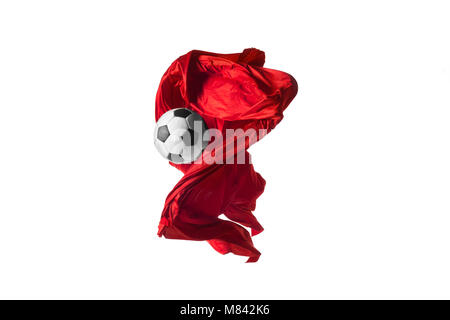 Soccer ball and Smooth elegant transparent red cloth isolated or separated on white studio background. Stock Photo