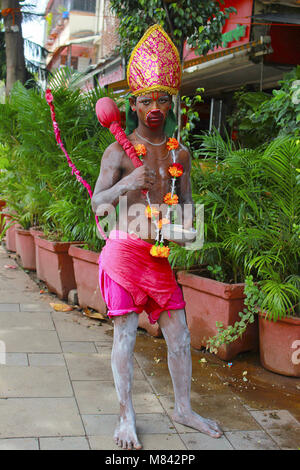 Boy dressed up as Hanuman the monkey god in bright colours and a painted face. Pandharpur festival