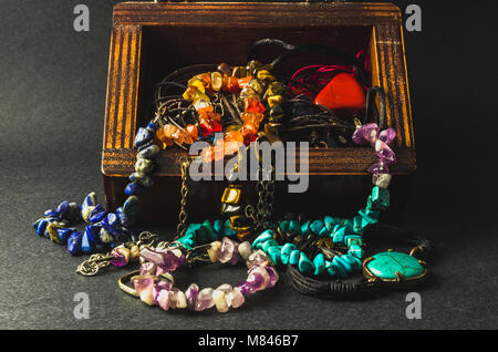 Macro of a wooden box and colorful jewelries Stock Photo