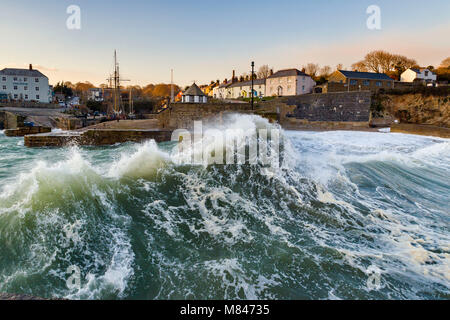 Huge waves dwarf the harbour at Charlestown as Storm Emma makes landfall. Storm Emma brought deep ocean swells as well as high winds and snow. Stock Photo