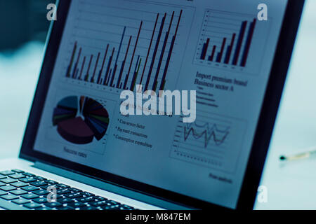 laptop screen with financial chart on a workplace of the businessman Stock Photo