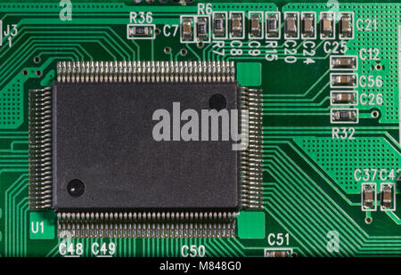 Macro image of electronic circuits and microprocessors on green electronic board. Stock Photo
