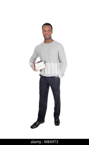 A handsome serious young African American man standing and holding his books in his hands, isolated for white background Stock Photo