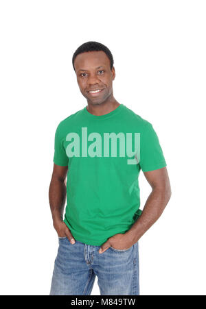 A young happy African American man in a green t-shirt and jeans standing smiling, isolated for white background Stock Photo