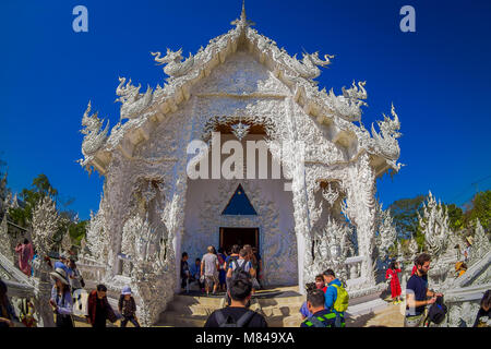 CHIANG RAI, THAILAND - FEBRUARY 01, 2018: Crowd of tourist at the enter of a ornate building at white temple located in Chiang Rai northern Thailand Stock Photo